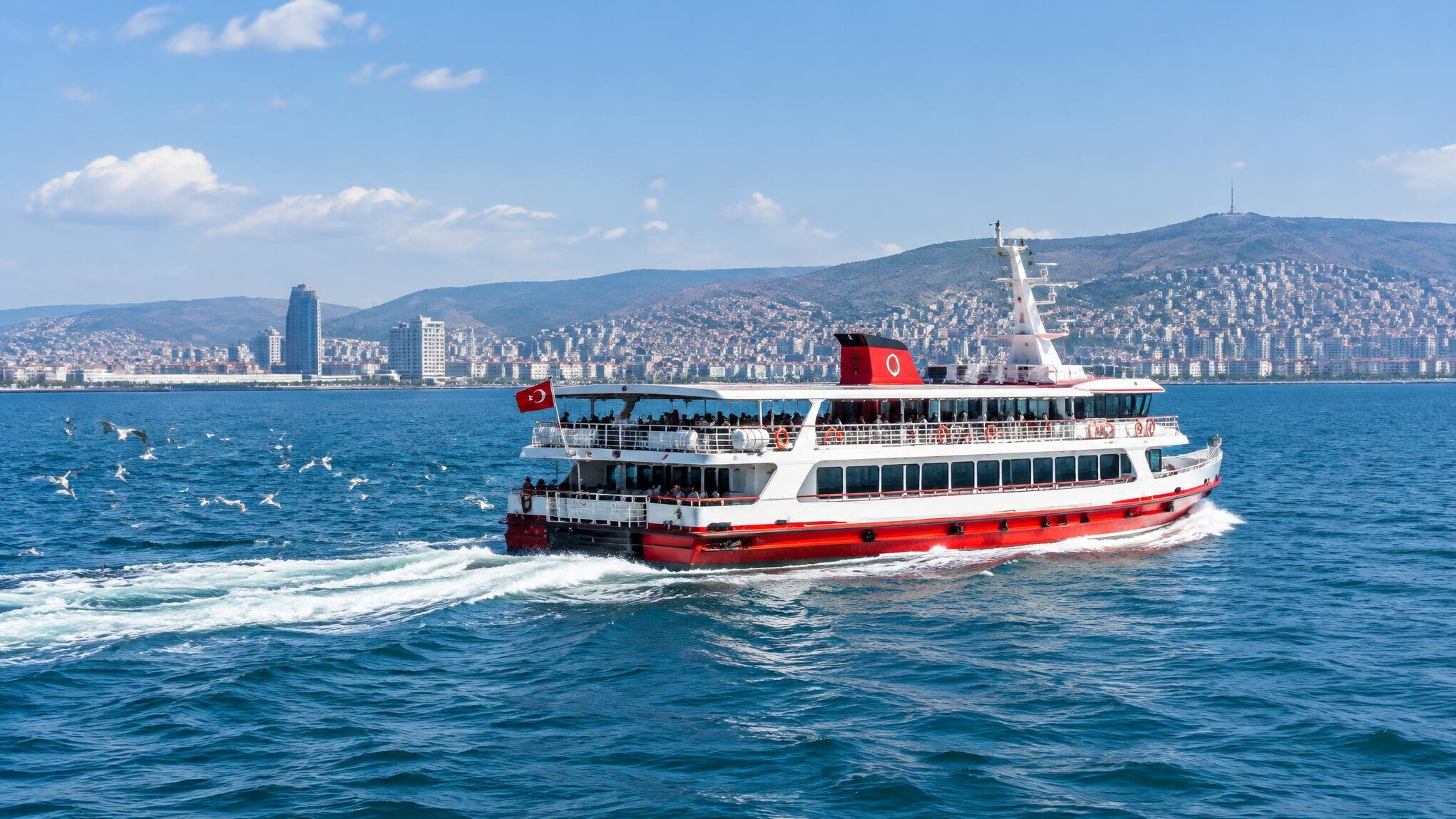 Passenger ferry crossing the Izmir gulf with seagulls