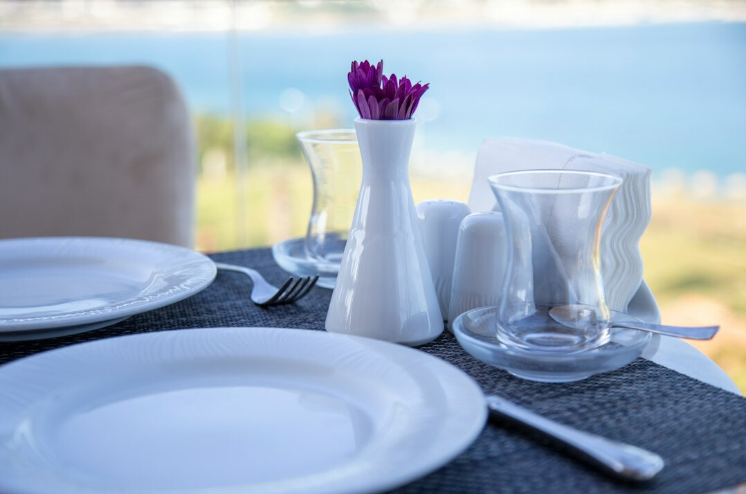 Turkish tea glasses on a small cafe table by the sea